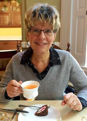 Wendi Hiebert, P.H.Ec. smiling with tea